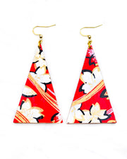 Large wooden long triangle shaped earrings featuring white cherry blossoms with black outlines on a red background with metallic gold and silver details.