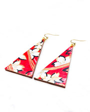 Large wooden long triangle shaped earrings featuring white cherry blossoms with black outlines on a red background with metallic gold and silver details.