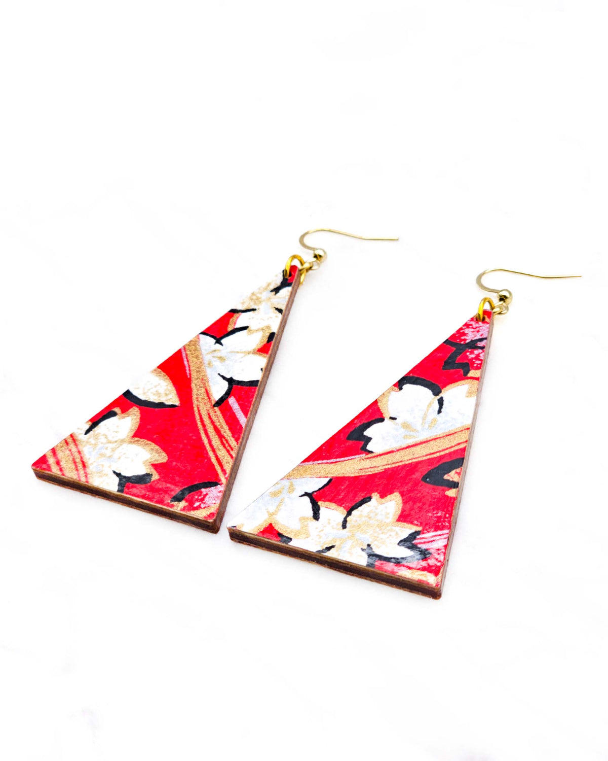 Large wooden long triangle shaped earrings featuring white cherry blossoms with black outlines on a red background with metallic gold and silver details.