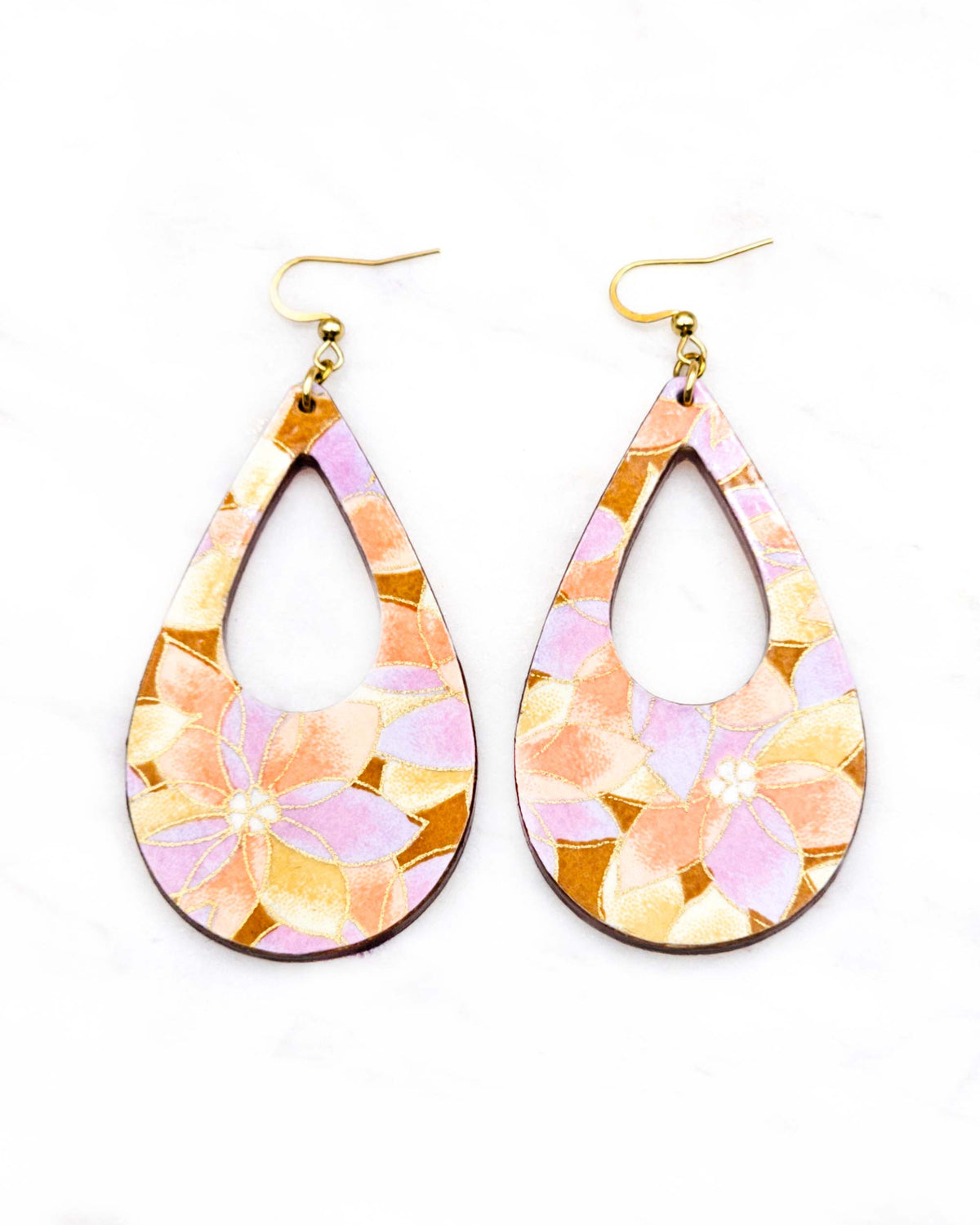 Large wooden hollow teardrop earrings featuring orange, brown, and light purple lotuses on a brown background with metallic gold details.