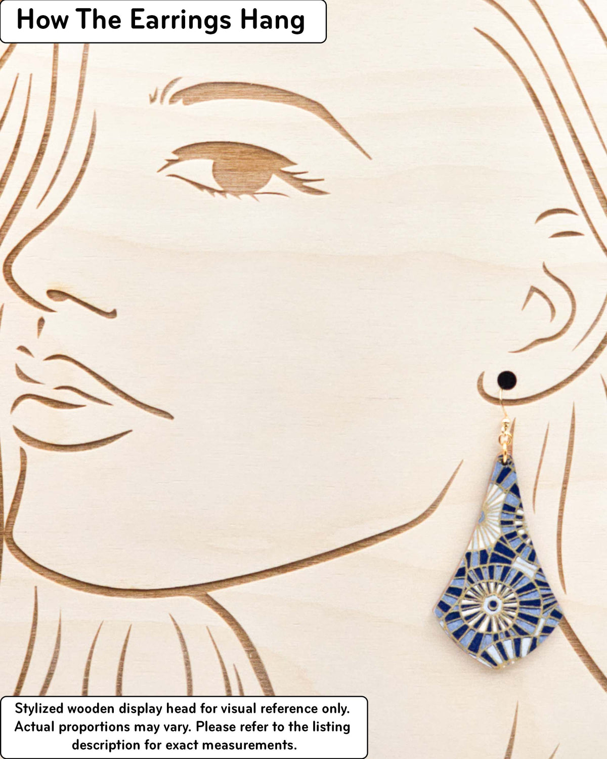 Large wooden long anchor earrings featuring overlapping blue and white parasols with metallic gold details, displayed on a stylized wooden head to demonstrate how the earring hangs when worn. Display is not to scale.