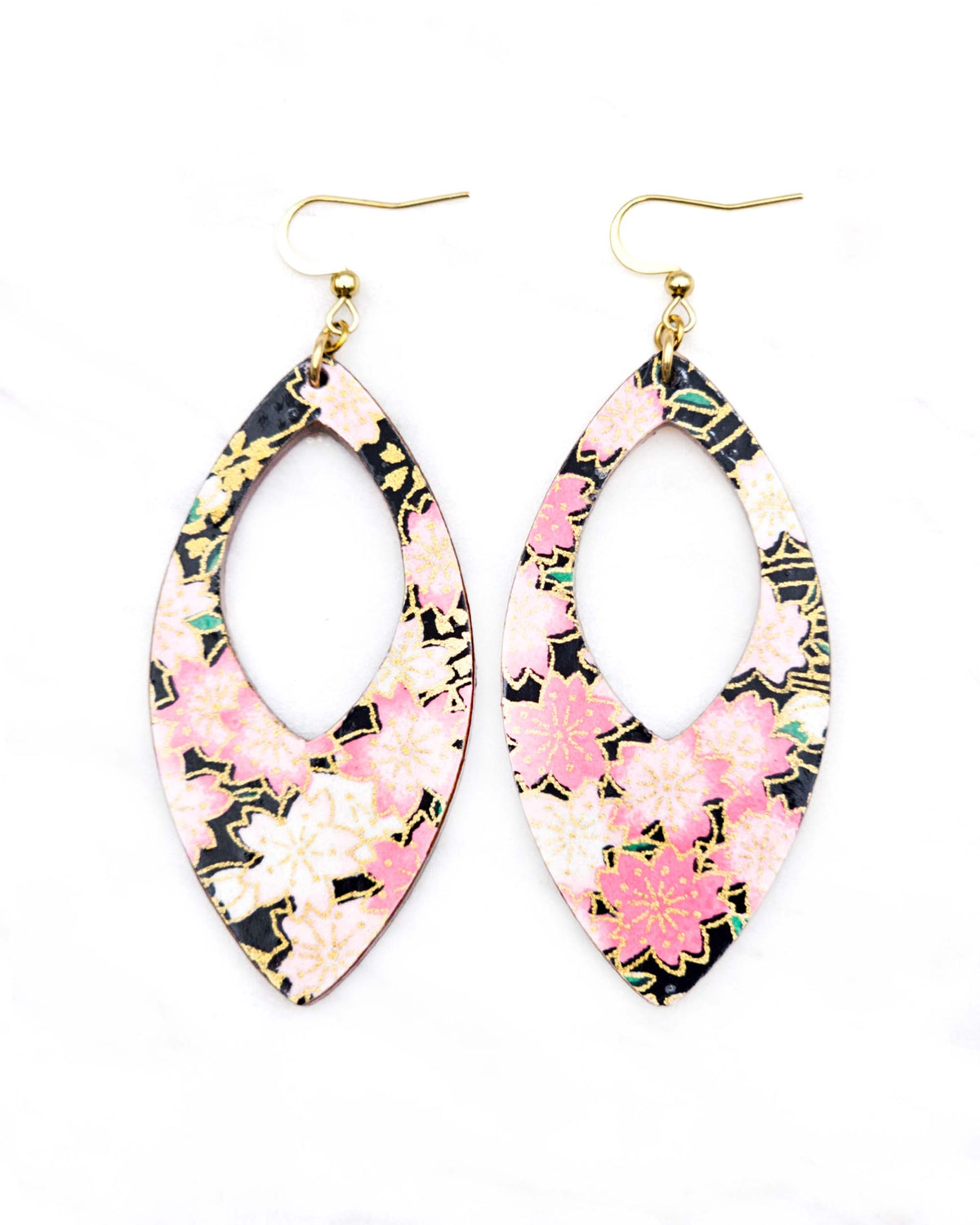 Large wooden hollow pointed oval shaped earrings featuring pink and white cherry blossoms on a black background with metallic gold details.