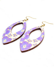 Large wooden hollow pointed oval shaped earrings featuring purple cherry blossoms on a cream background with metallic silver details.