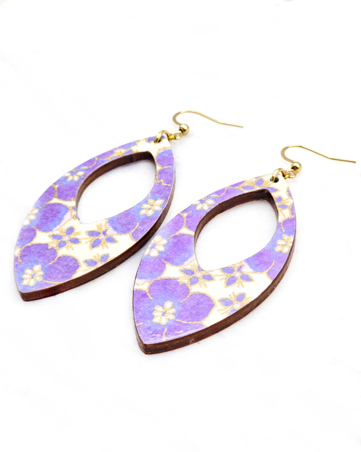 Large wooden hollow pointed oval shaped earrings featuring purple cherry blossoms on a cream background with metallic silver details.