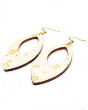 Large wooden hollow pointed oval shaped earrings featuring small white and metallic gold cherry blossoms on pearlescent cream background with metallic silver details.