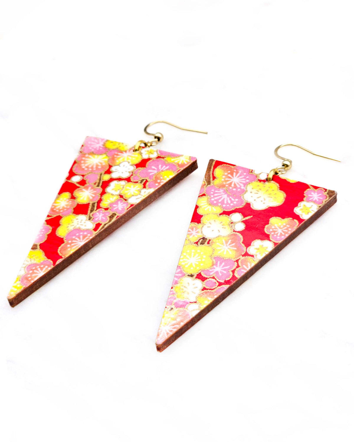 Large wooden long triangle shaped earrings featuring pink, yellow, and white plum blossom trees with brown branches on a red background with metallic gold details.
