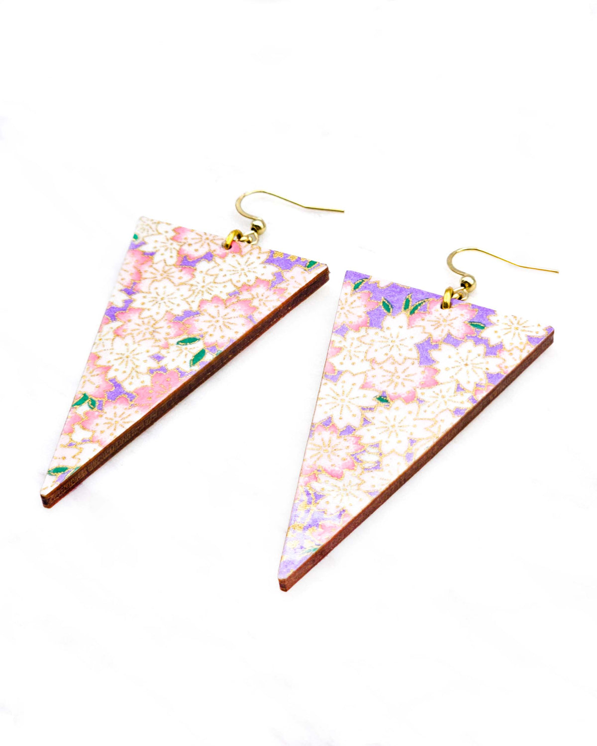 Large wooden long triangle shaped earrings featuring pink and white cherry blossoms on a pearlescent light purple background with metallic gold details.