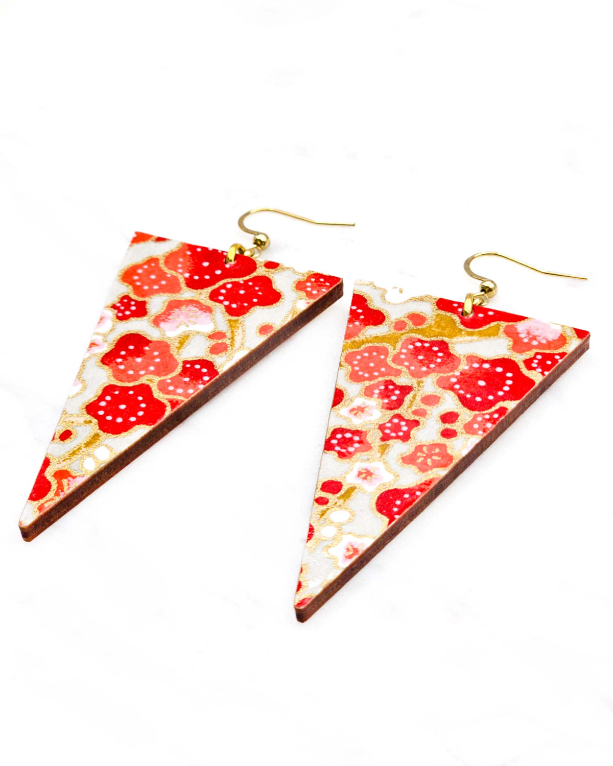 Large wooden long triangle shaped earrings featuring red white plum blossoms with light brown branches on a gray background with metallic gold details.