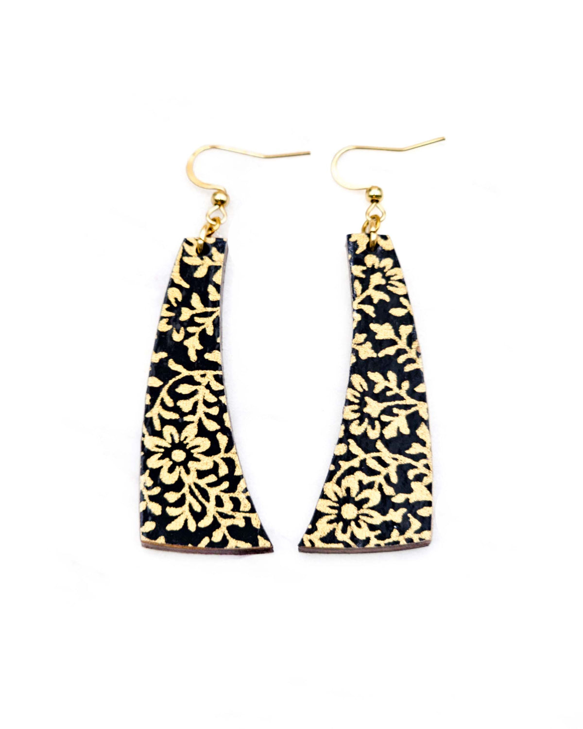 Medium wooden curved bar shaped earrings featuring a metallic gold floral motif on a black background.