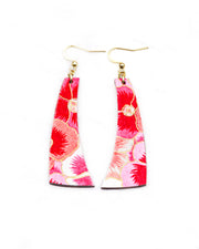 Medium wooden curved bar shaped earrings featuring pink and white pansies with with metallic gold details.