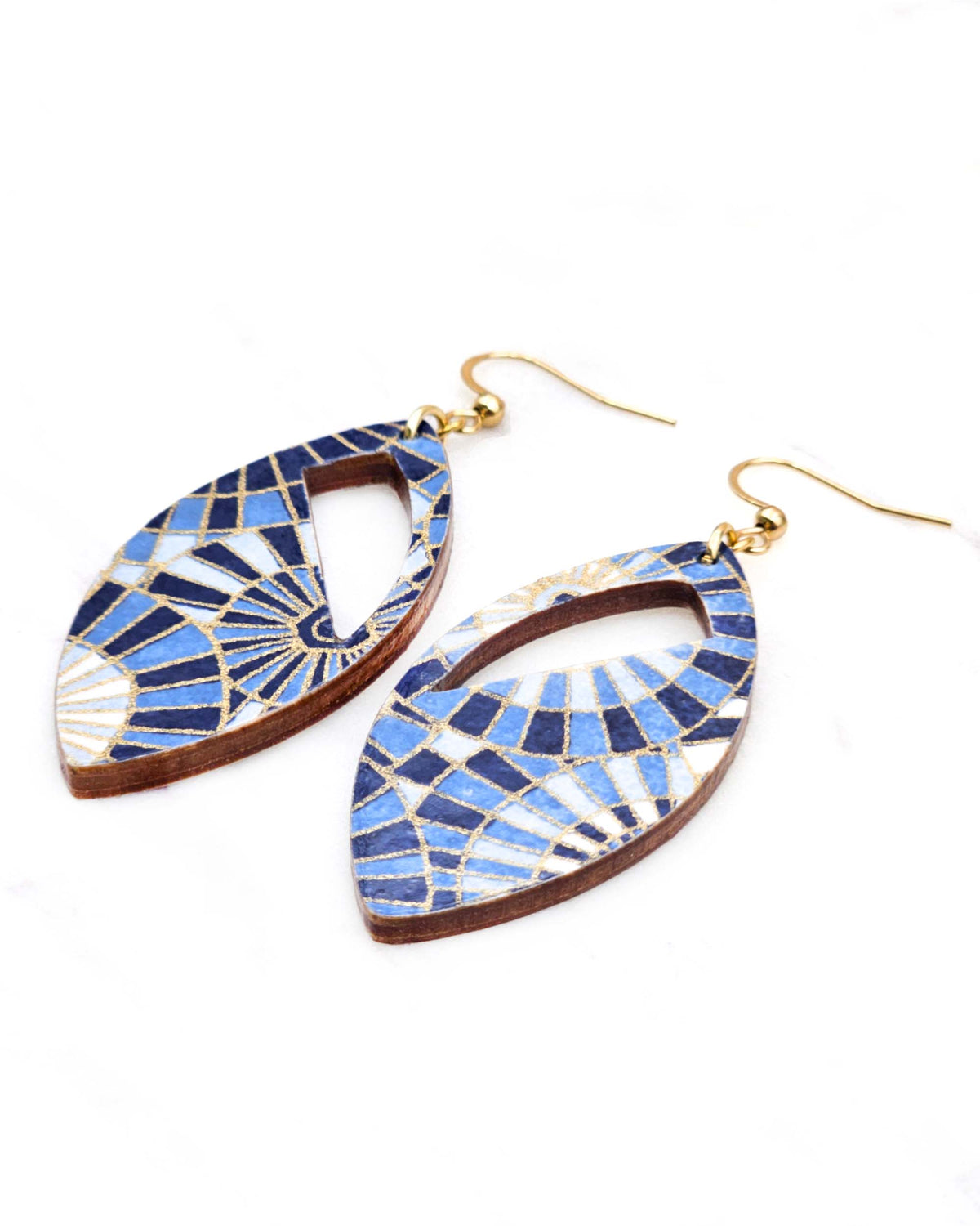 Medium wooden cutout pointed oval shaped earrings featuring blue and white overlapping parasols with metallic gold details