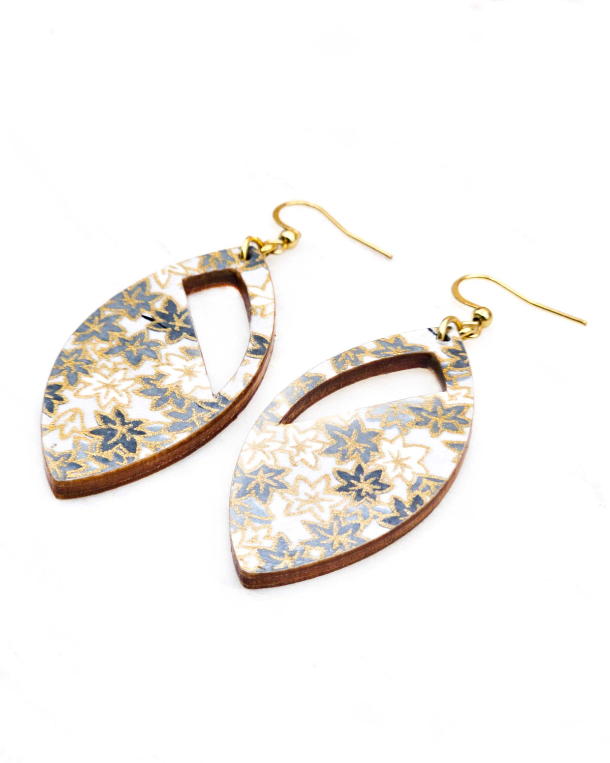 Medium wooden cutout pointed oval shaped earrings featuring small gray and white momiji (maple leaves) on a light gray background with metallic gold details.