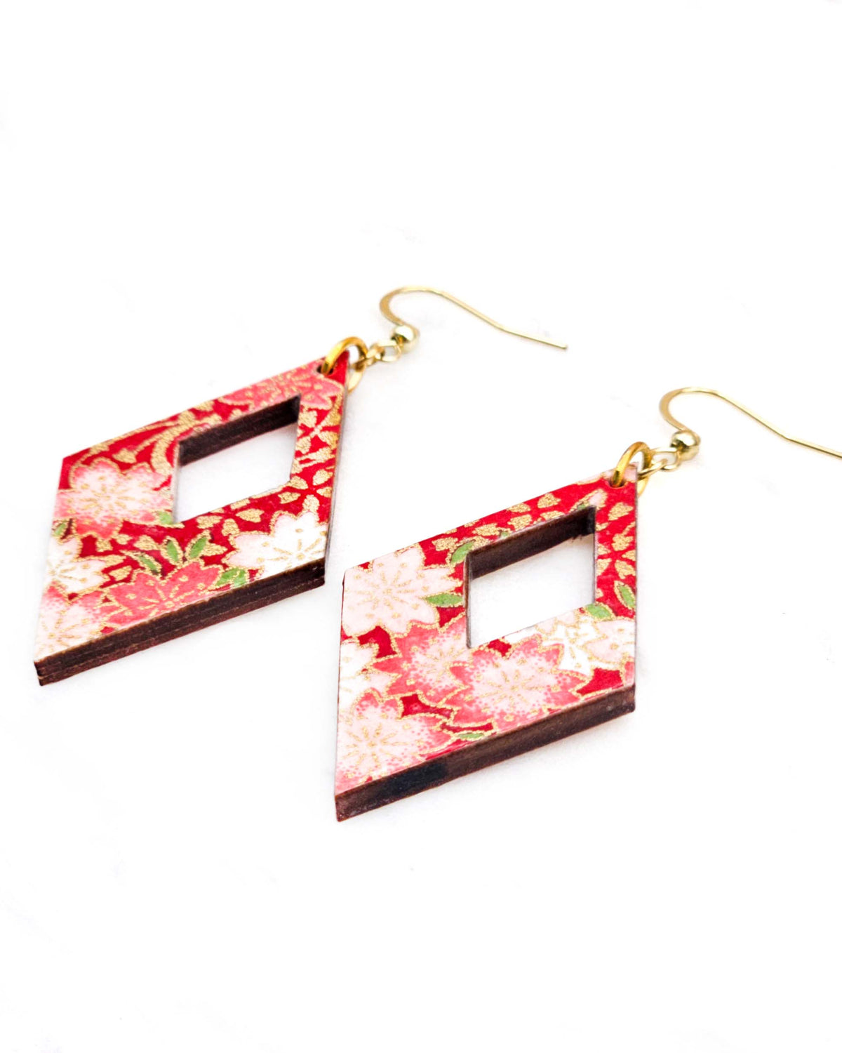 Medium wooden hollow diamond shaped earrings featuring red and white cherry blossoms on a red background with metallic gold details.