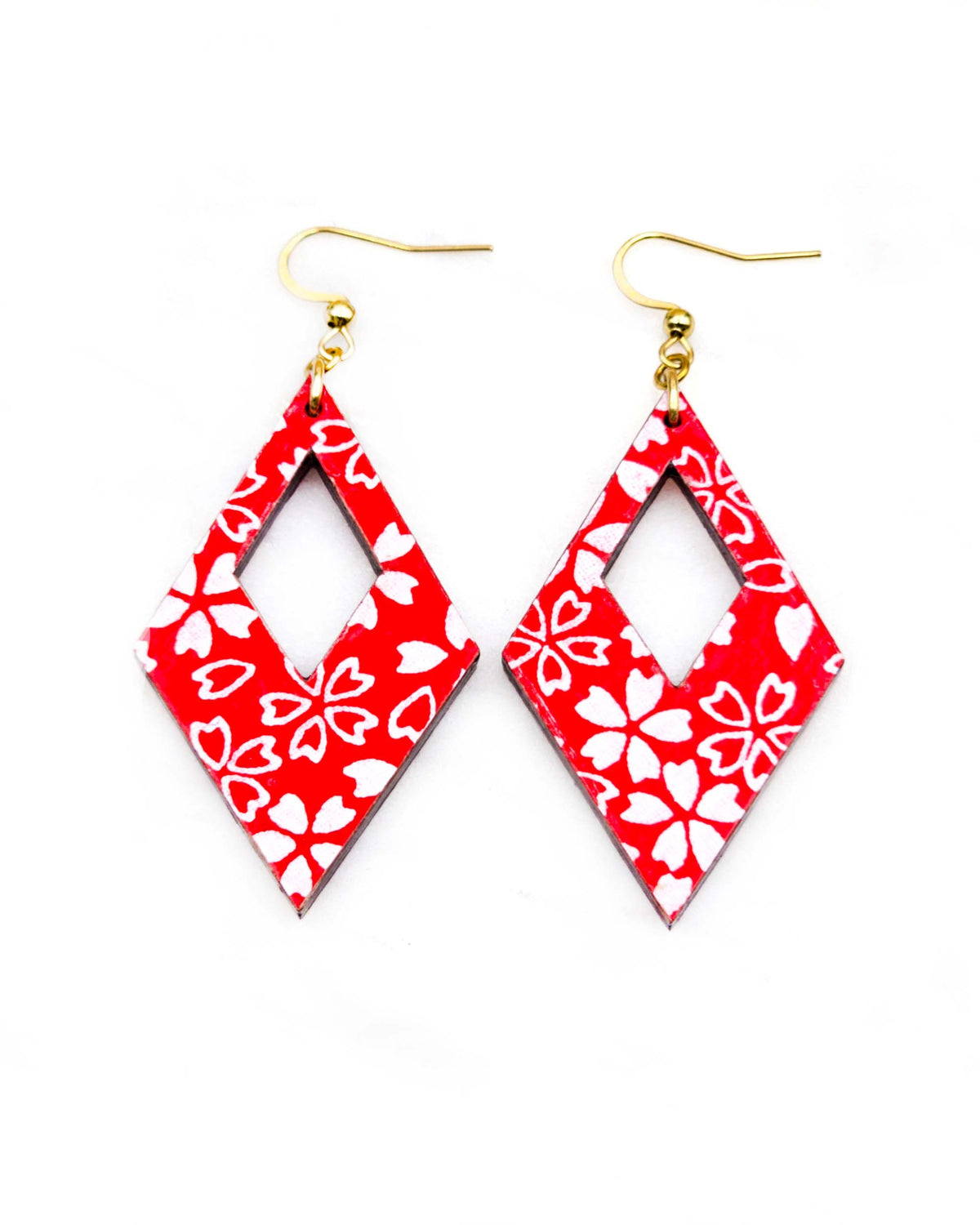 Medium wooden hollow diamond shaped earrings featuring small white cherry blossoms and cherry blossom outlines on a red background.