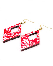 Medium wooden hollow diamond shaped earrings featuring small white cherry blossoms and cherry blossom outlines on a red background.