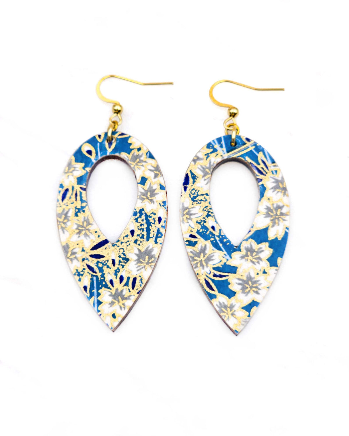 Medium wooden hollow reverse teardrop shaped earrings featuring white cherry blossoms on a blue background with metallic gold details