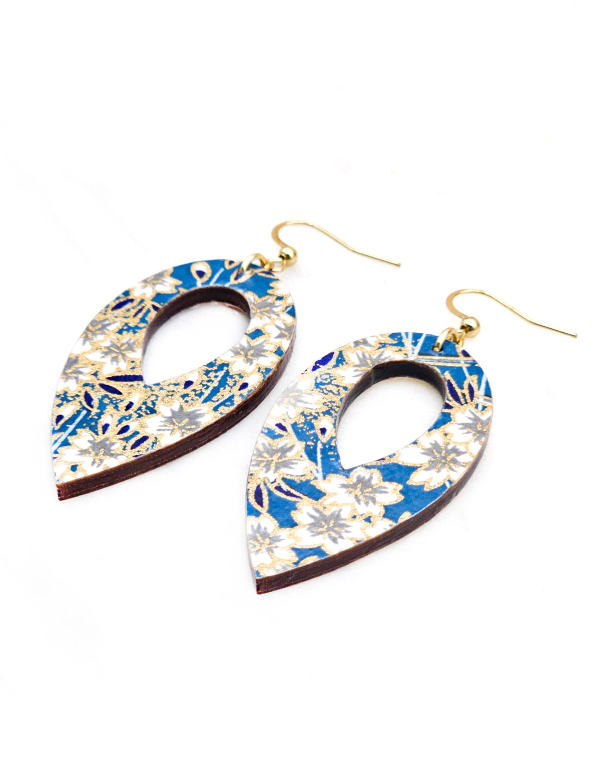 Medium wooden hollow reverse teardrop shaped earrings featuring white cherry blossoms on a blue background with metallic gold details