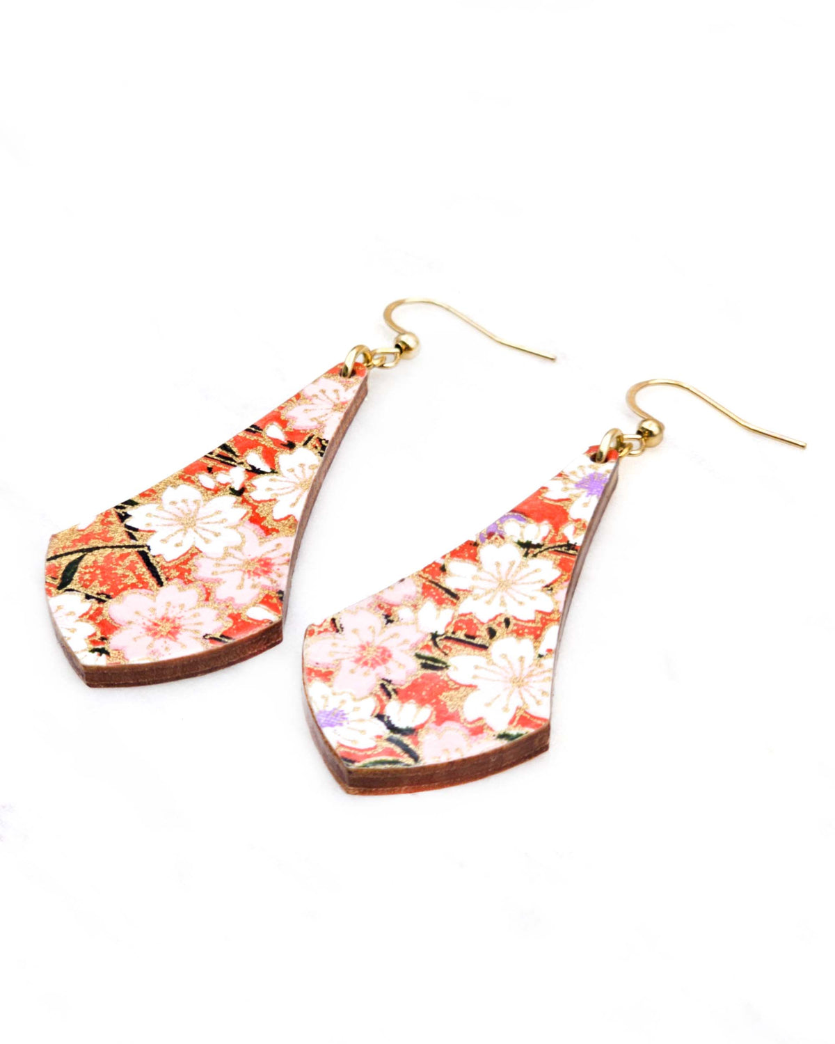 Medium wooden long anchor shaped earrings featuring white and pink cherry blossoms on a reddish orange background with metallic gold details.