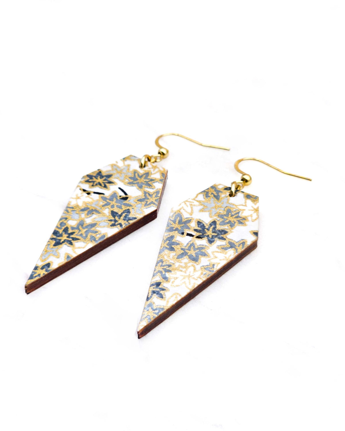 Medium wooden long diamond shaped earrings featuring small gray and white momiji (maple leaves) on a light gray background with metallic gold details.
