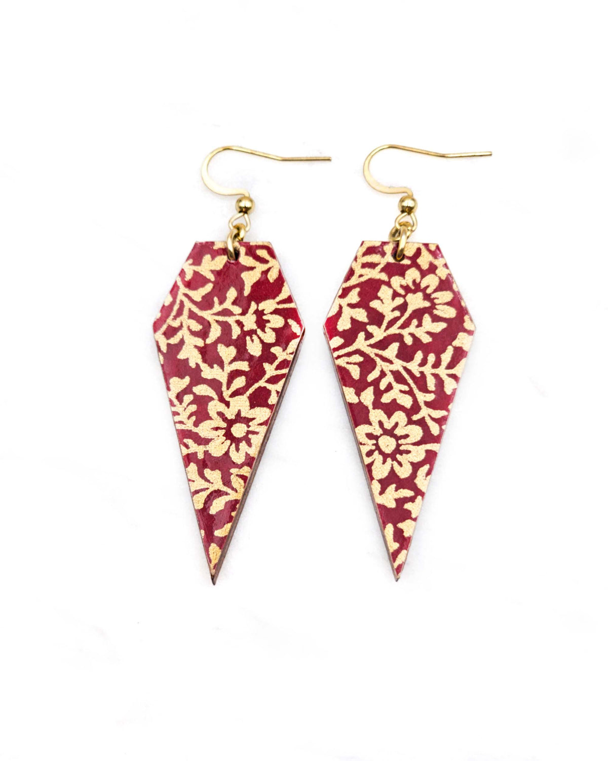 Medium wooden long diamond shaped earrings featuring a metallic gold floral design on a red background.