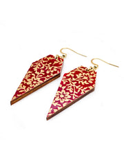 Medium wooden long diamond shaped earrings featuring a metallic gold floral design on a red background.