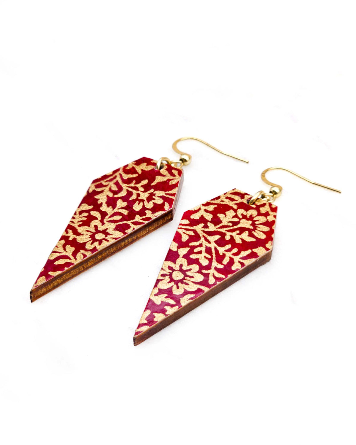 Medium wooden long diamond shaped earrings featuring a metallic gold floral design on a red background.