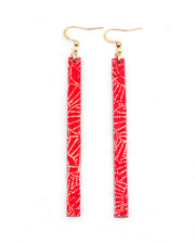 Medium wooden long thin bar shaped earrings featuring small metallic gold pointillistic temari balls on a red background
