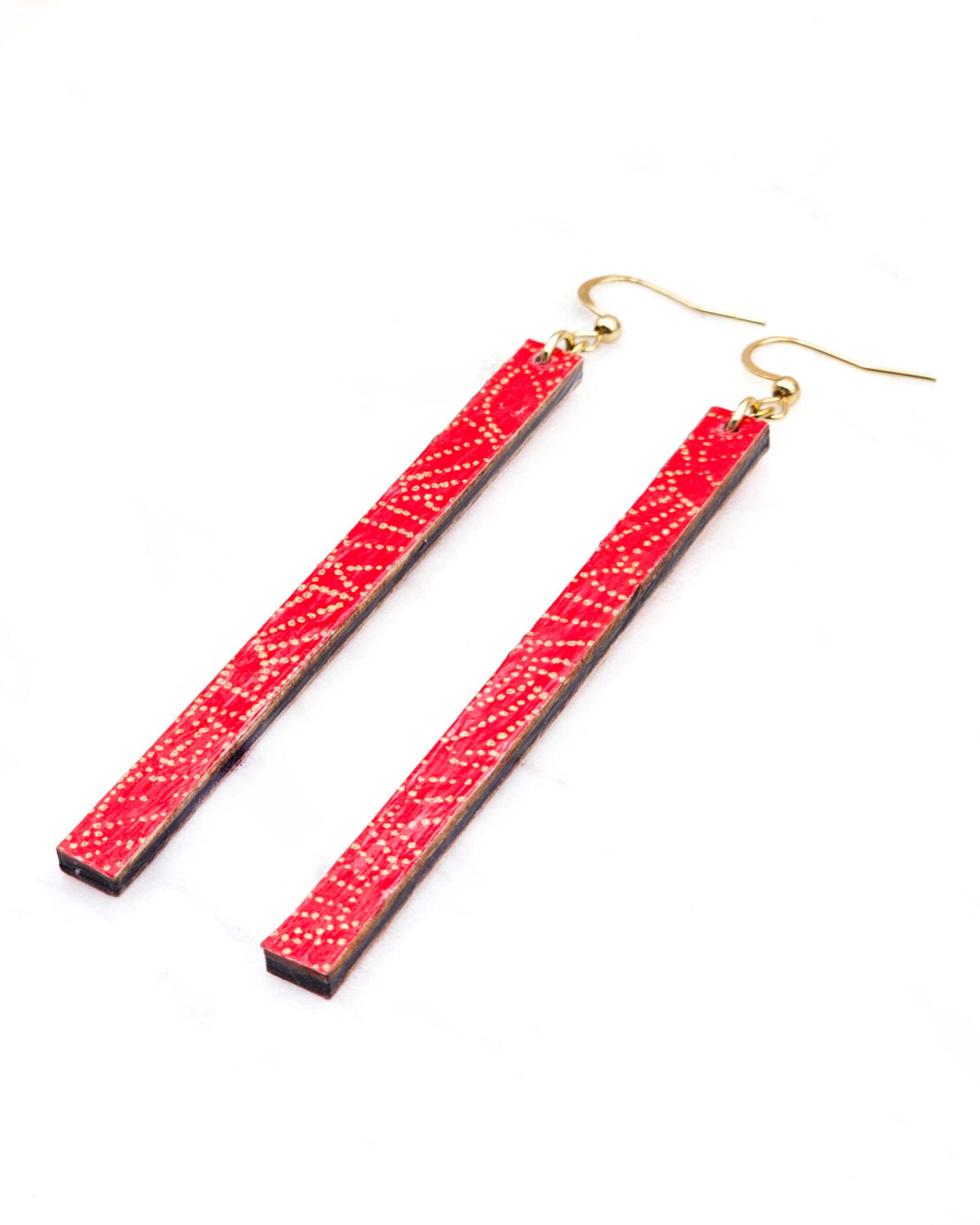 Medium wooden long thin bar shaped earrings featuring small metallic gold pointillistic temari balls on a red background