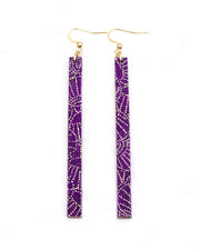 Medium wooden long thin bar shaped earrings featuring small metallic gold pointillistic temari balls on a dark purple background