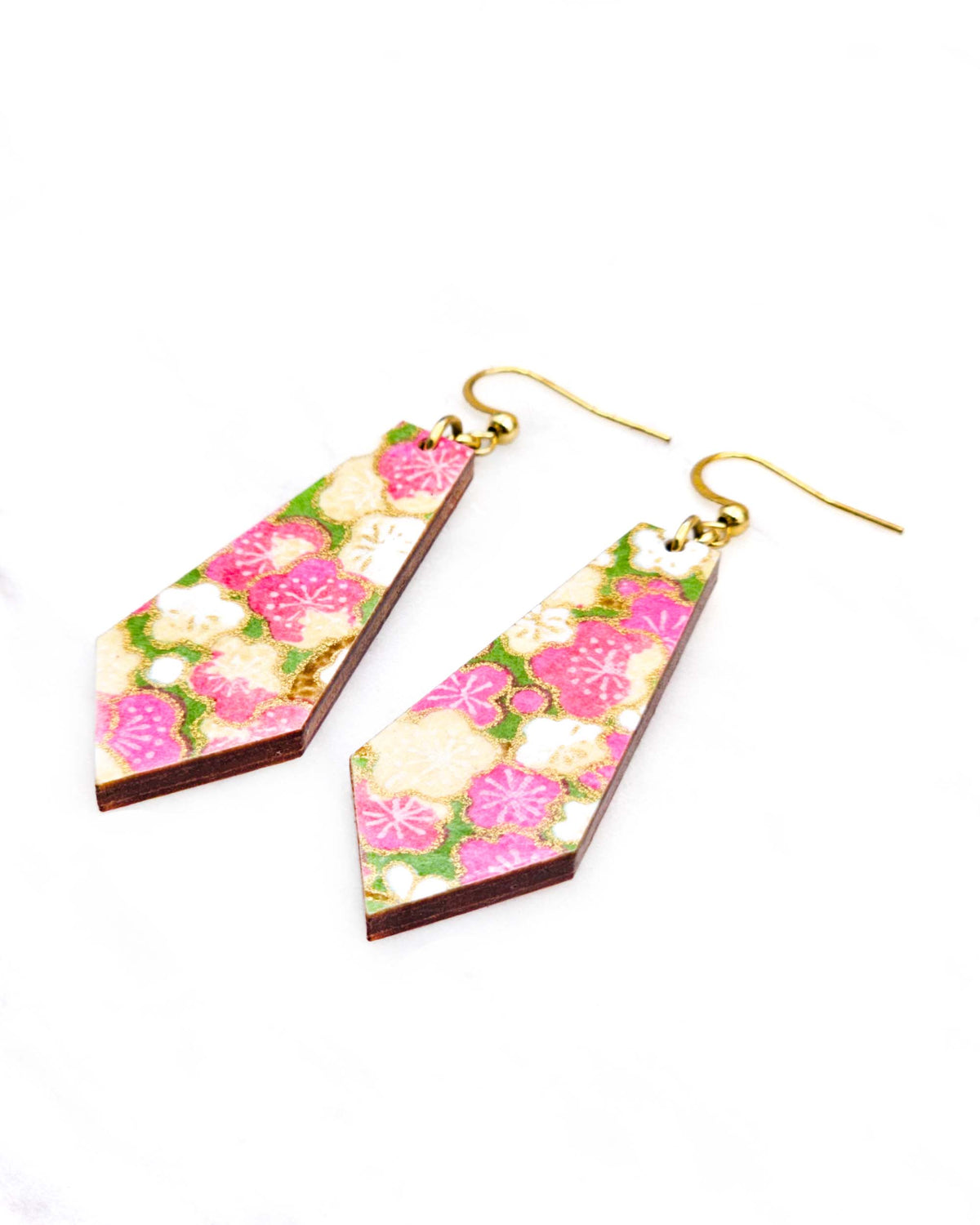 Medium wooden pointed tapered bar shaped earrings featuring pink and beige plum blossoms on a green background with metallic gold details.