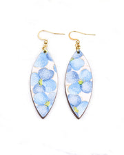 Medium wooden thin pointed oval shaped earrings featuring blue flowers on a pink background with metallic gold details.