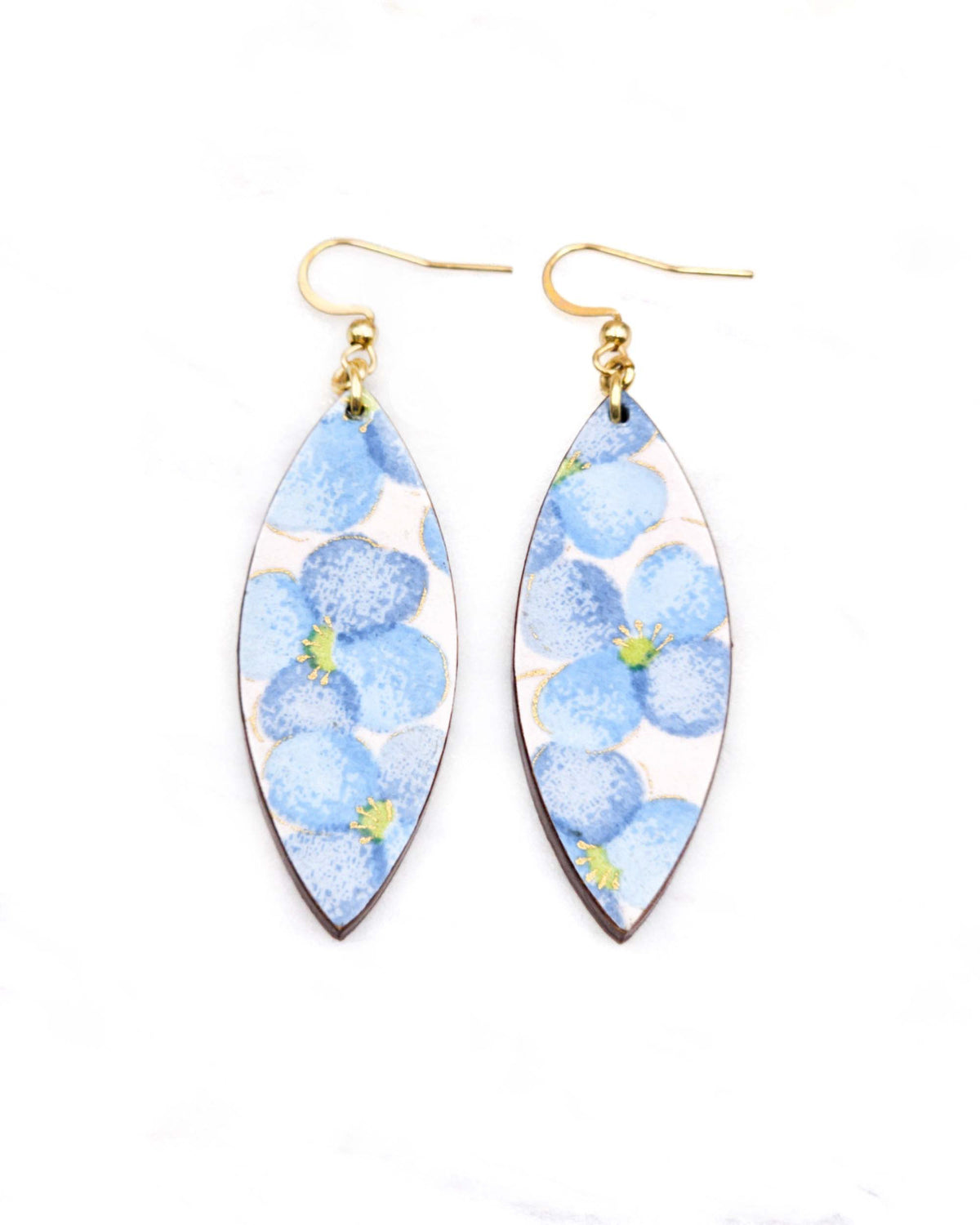 Medium wooden thin pointed oval shaped earrings featuring blue flowers on a pink background with metallic gold details.