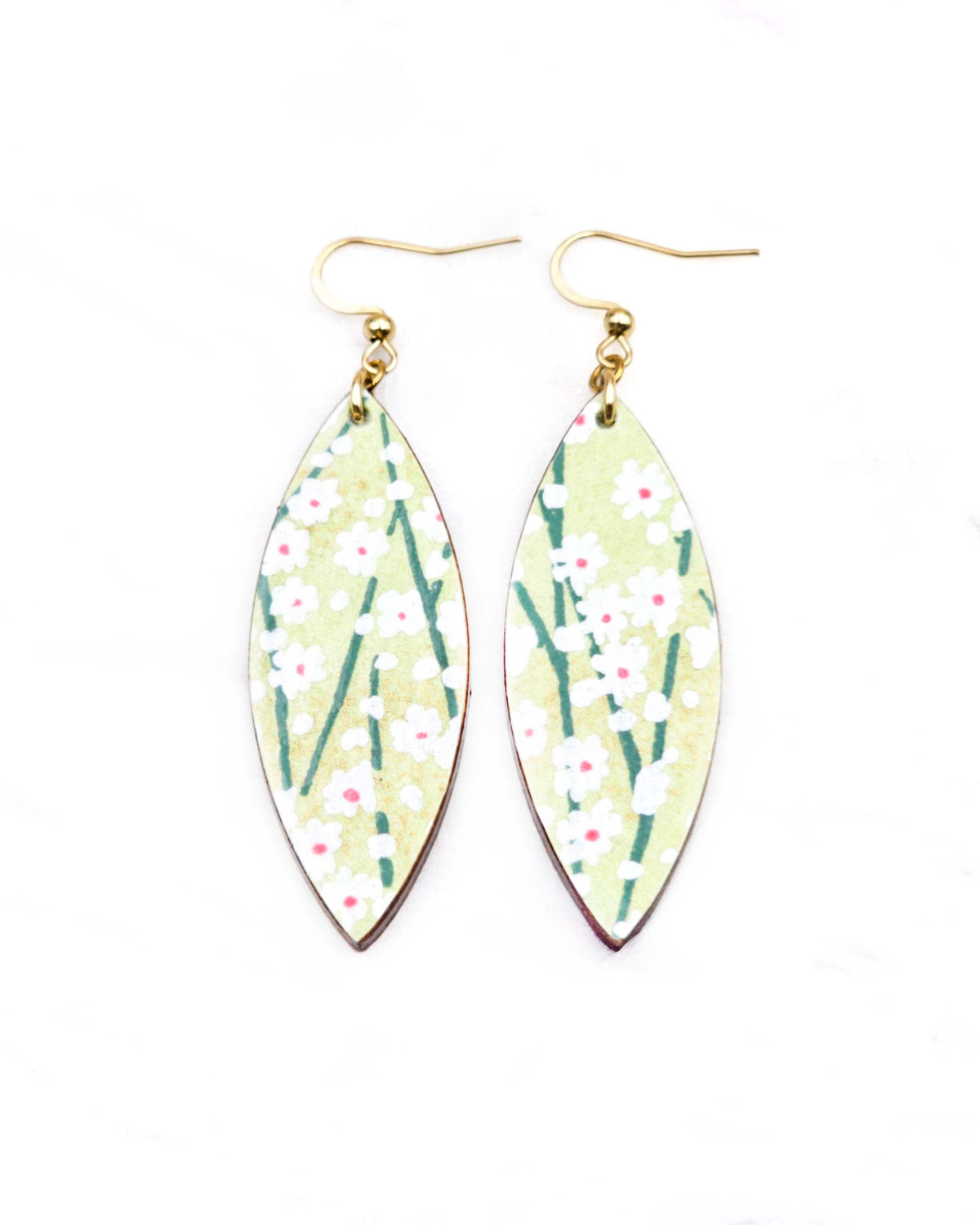 Medium wooden thin pointed oval shaped earrings featuring small white flower bushes with green stems over a yellow green background with metallic gold details.