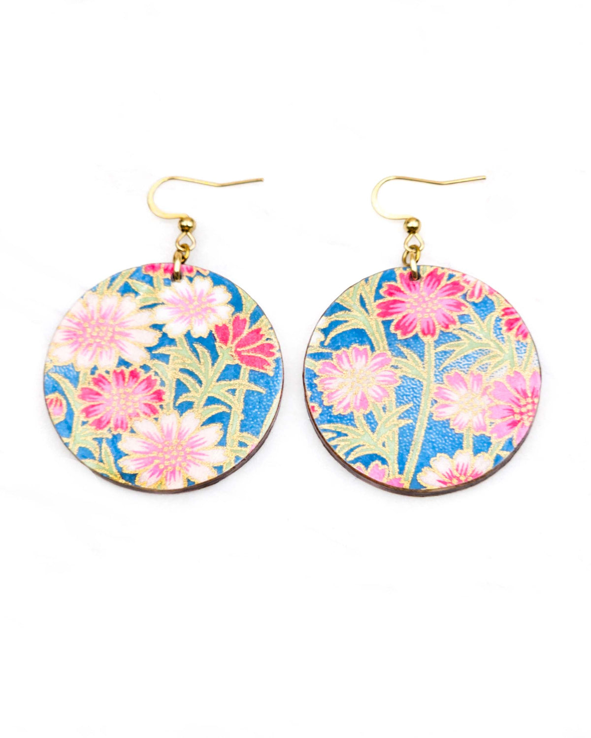 Medium wooden circle shaped earrings featuring pink and white flowers with green stems on a blue background with metallic gold details.