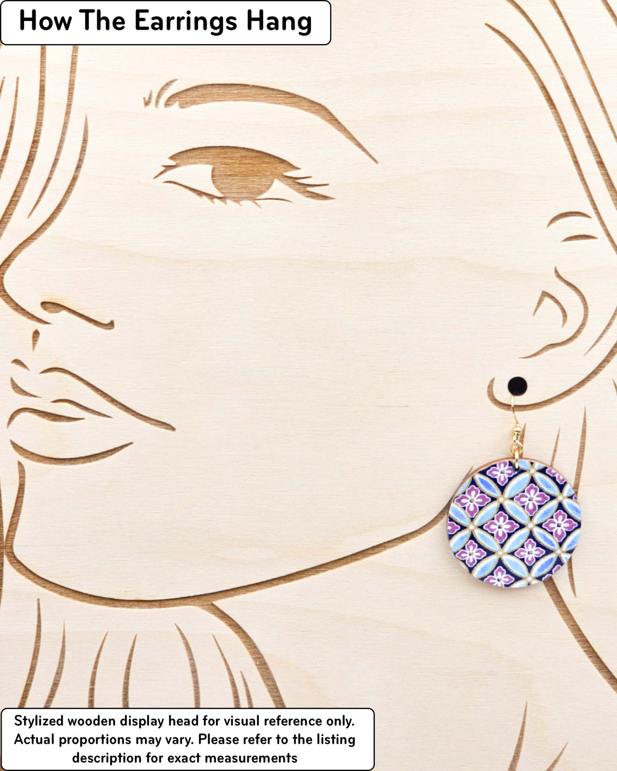Medium wooden circle shaped earrings featuring a blue shippo design with purple hanabishi in the center with metallic gold details, displayed on a stylized wooden head to demonstrate how the earring hangs when worn. Display is not to scale.