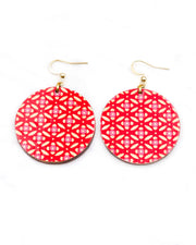 Medium wooden circle shaped earrings featuring a gold shippo design with pink centers on a red background