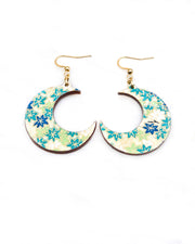 Medium wooden crescent moon shaped earrings featuring small green and white momiji (maple leaves) on a light green background with metallic gold details.
