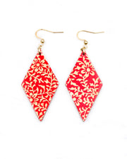 Medium wooden diamond shaped earrings featuring a metallic gold floral motif on a bright red background.
