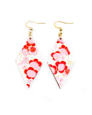 Medium wooden diamond shaped earrings featuring pink plum blossoms on a pearlescent white background with metallic gold accents.