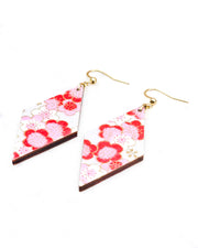 Medium wooden diamond shaped earrings featuring pink plum blossoms on a pearlescent white background with metallic gold accents.