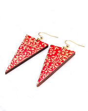 Medium wooden downward triangle shaped earrings featuring a metallic gold floral motif on a bright red background.