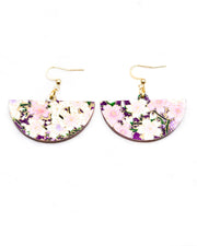 Medium wooden half circle shaped earrings featuring light pink and white cherry blossoms on a dark purple background with metallic gold details.