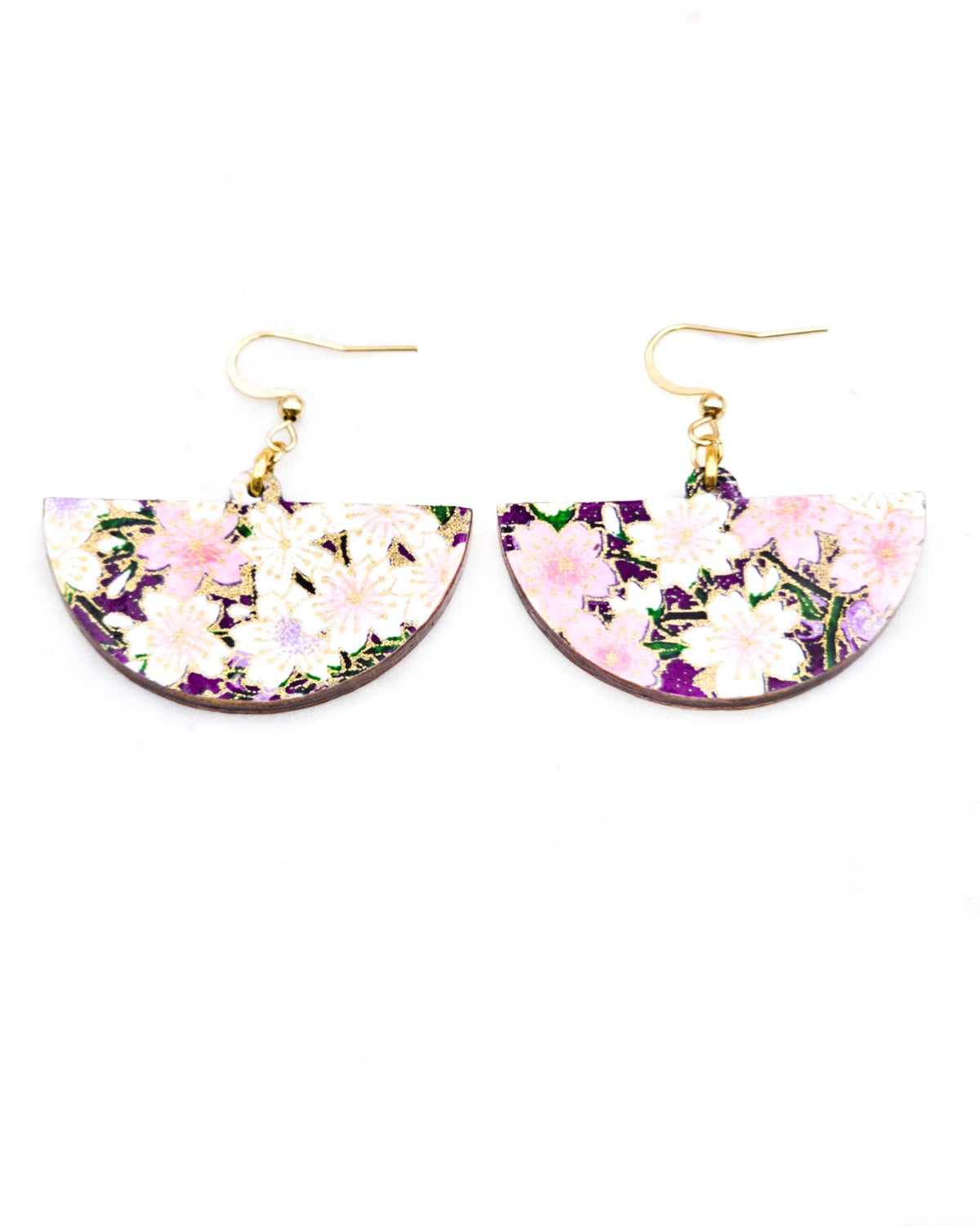 Medium wooden half circle shaped earrings featuring light pink and white cherry blossoms on a dark purple background with metallic gold details.