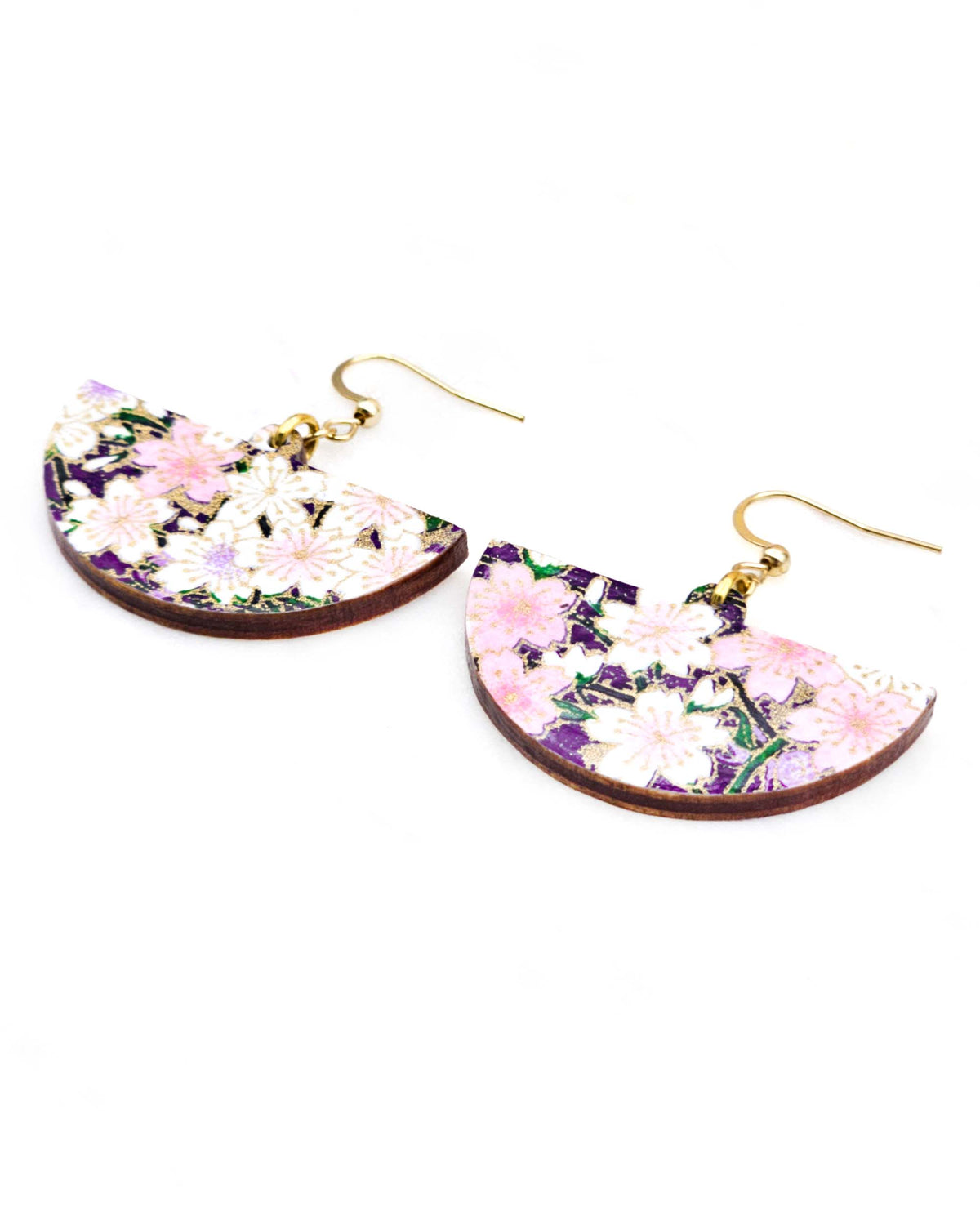 Medium wooden half circle shaped earrings featuring light pink and white cherry blossoms on a dark purple background with metallic gold details.