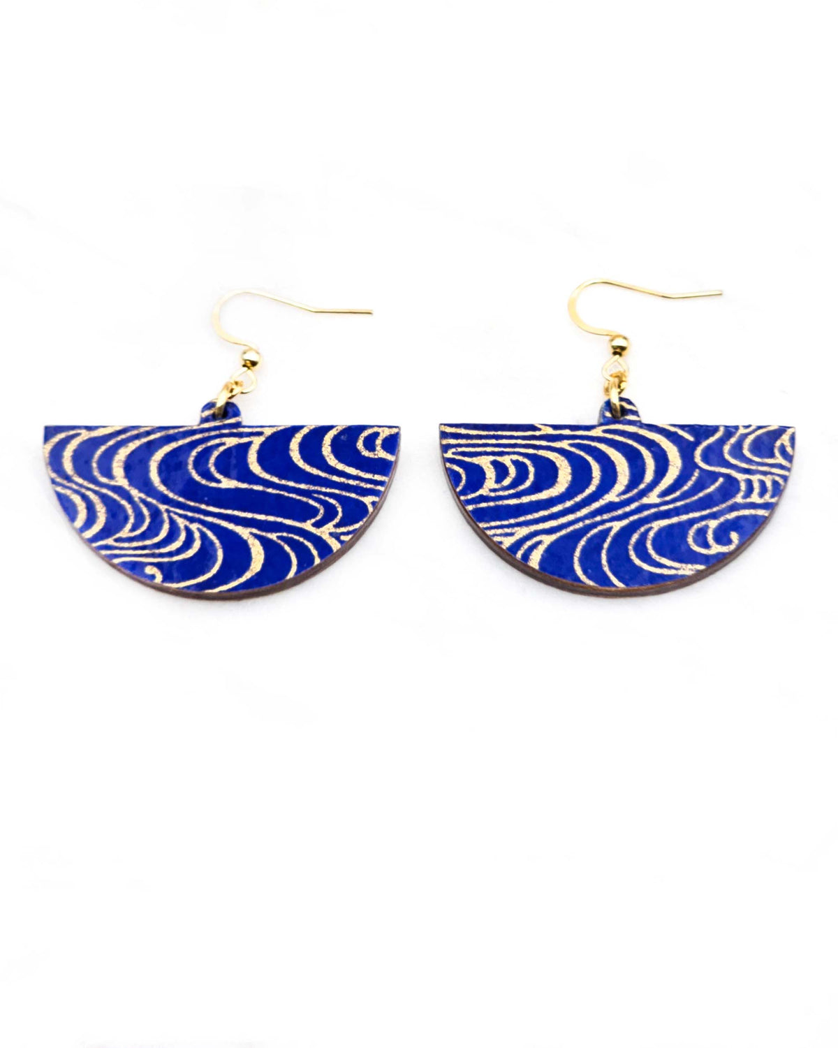 Medium wooden half circle shaped earrings featuring metallic gold water ripples on a dark blue background.