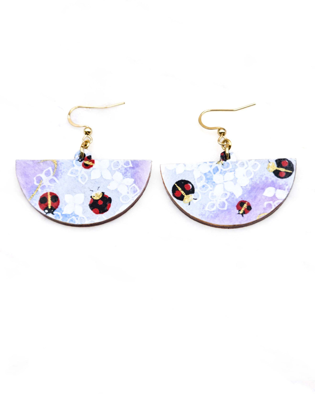 Medium wooden half circle shaped earrings featuring ladybugs on a purple and blue background with metallic gold details.