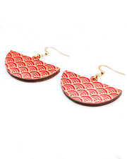 Medium wooden half circle shaped earrings featuring a traditional red and metallic gold seigaiha (wave crests) pattern