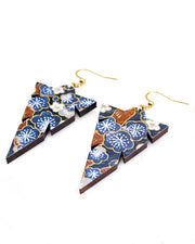 Medium wooden notched triangle shaped earrings featuring blue and gray plum blossoms with brown branches on a dark blue background with metallic gold details.