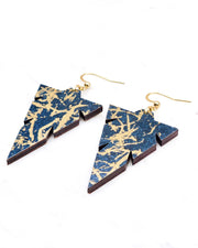 Medium wooden notched triangle shaped earrings featuring metallic gold fibers in the style of traditional unryu paper on a dark blue background.