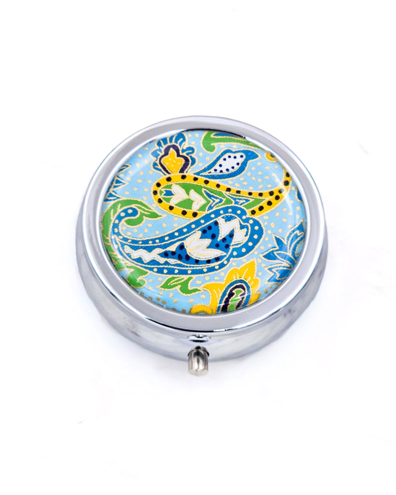 Silver metal pill box featuring a green and yellow paisley design on a light blue background with metallic gold accents.